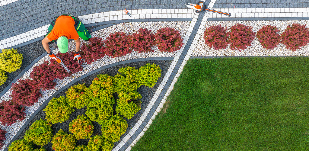 Commercial property landscape with maintained turf and beds in Birmingham Alabama during summer